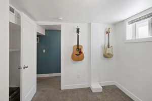 Interior space with carpet floors, visible vents, and baseboards