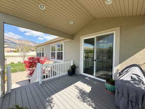 Wooden terrace featuring a grill, a mountain view, and fence