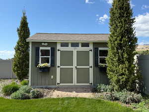 View of shed with fence