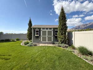 View of shed featuring a mountain view and fence