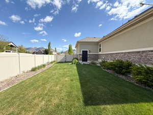 View of yard featuring a gate and a fenced backyard