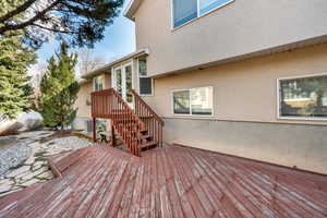 Wooden deck featuring central air condition unit