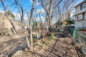 View of yard featuring fence