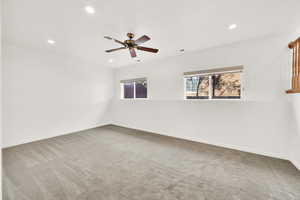 Carpeted spare room featuring visible vents, baseboards, a ceiling fan, and recessed lighting
