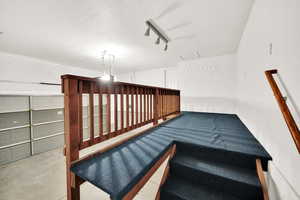 Staircase with rail lighting and concrete floors