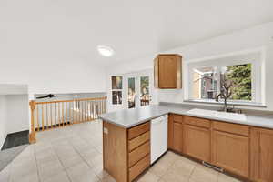 Kitchen featuring light tile patterned floors, a sink, visible vents, dishwasher, and plenty of natural light
