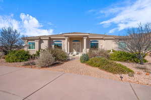 View of front of property with a tiled roof, a gate, and stucco siding