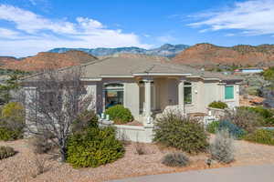 View of front of home with a tiled roof, a mountain view, and stucco siding