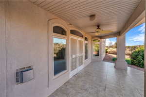View of patio with heating unit and a ceiling fan