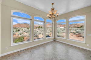 Interior space featuring baseboards, visible vents, a textured ceiling, a mountain view, and a notable chandelier