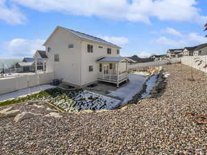 Rear view of property with a fenced backyard, a patio, and stucco siding