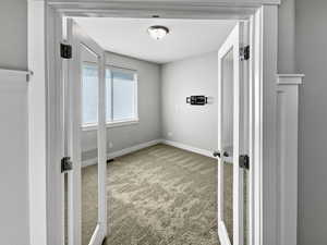 Unfurnished bedroom featuring carpet floors and baseboards