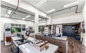 Kitchen featuring dark wood-type flooring, blue cabinets, and stainless steel oven