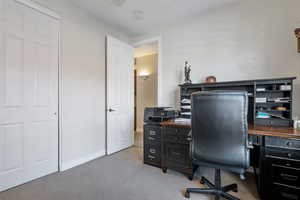 Office featuring light colored carpet, ceiling fan, and baseboards