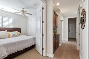 Bedroom featuring ceiling fan, visible vents, baseboards, a closet, and light wood-type flooring