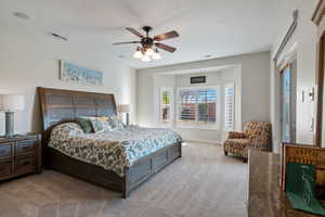 Bedroom featuring a ceiling fan, baseboards, visible vents, and carpet flooring