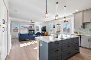 Kitchen featuring gray cabinets, a sink, and light countertops