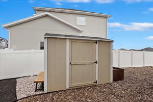 View of shed with fence