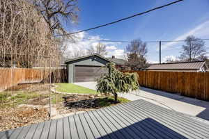 Deck featuring a fenced backyard and an outdoor structure