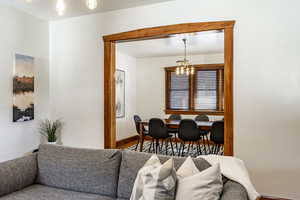 Living room featuring an inviting chandelier and wood finished floors