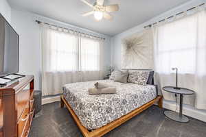 Bedroom featuring dark carpet and a ceiling fan