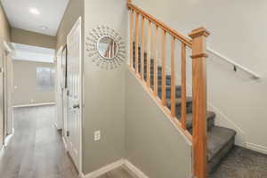 Stairs featuring baseboards and wood finished floors