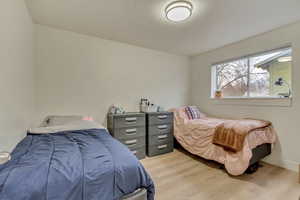 Bedroom featuring light wood-type flooring and baseboards
