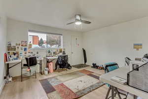 Office featuring ceiling fan, baseboards, and wood finished floors