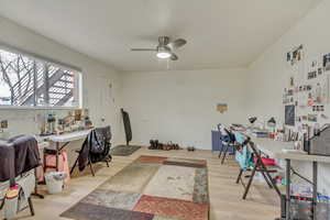 Office featuring a ceiling fan, baseboards, and wood finished floors