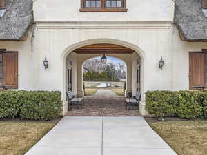 Entrance to property featuring a porch and stucco siding