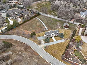 Aerial view of property and surrounding area featuring nearby suburban area