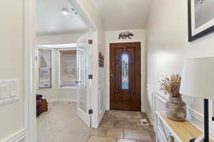 Entryway featuring visible vents and light colored carpet