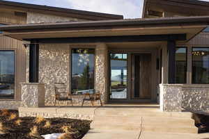 View of exterior entry featuring covered porch