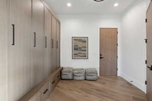 Interior space with baseboards, recessed lighting, and light wood-style floors