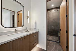 Full bathroom featuring a stall shower, marble finish floor, vanity, and recessed lighting