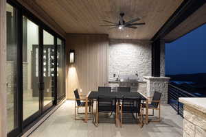 View of patio / terrace featuring an outdoor kitchen, grilling area, outdoor dining area, and a ceiling fan