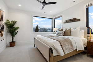 Carpeted bedroom with baseboards, visible vents, ceiling fan, and recessed lighting