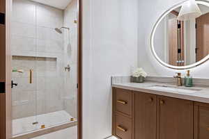 Full bathroom featuring a stall shower and vanity