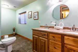 Full bathroom featuring visible vents, a sink, and double vanity