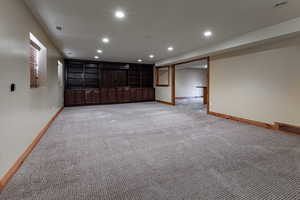 Unfurnished room with recessed lighting, visible vents, light carpet, and baseboards