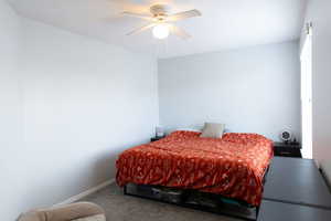 Bedroom featuring ceiling fan and carpet flooring