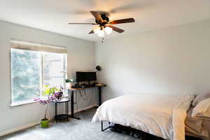 Bedroom with a ceiling fan, carpet, and baseboards