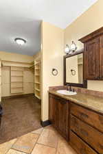 Bathroom with a spacious closet, dual vanity