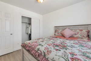 Bedroom featuring a closet and light wood-style floors