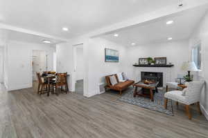 Living room with recessed lighting, wood finished floors, visible vents, and baseboards