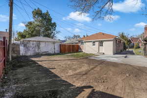 View of yard featuring entry steps, a fenced backyard, and an outdoor structure