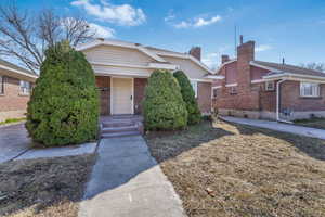 Bungalow-style home with a porch and brick siding