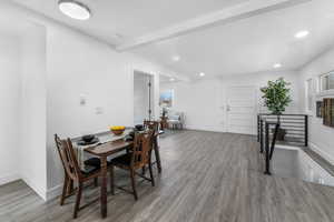 Dining room with recessed lighting, baseboards, wood finished floors, and beamed ceiling