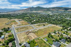 Aerial view of property and surrounding area with a mountainous background