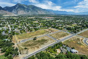 Aerial view of property's location with a mountain backdrop and property parcel outlined